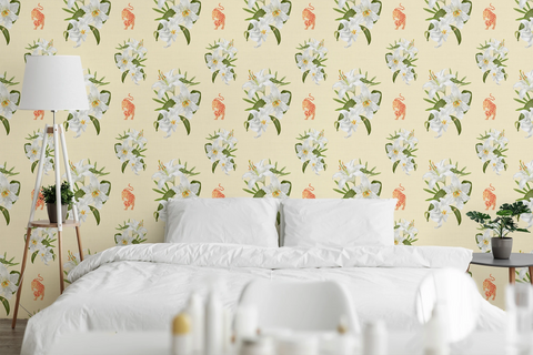 A styled bedroom scene featuring a bed with white bedding and pillows, set against a wall covered in a repeating floral wallpaper pattern with white flowers, green leaves, and small orange tigers on a pale yellow background.