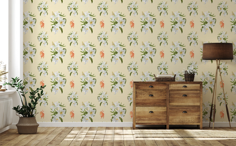 A room with wooden furniture, a potted plant on the floor, a standing lamp, and a wallpaper pattern of white lilies, orange tigers, on a cream yellow background. 
