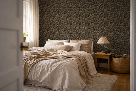 A modern bedroom with beige and white linens, a wooden nightstand, and the wall features a tapestry wallpaper with an oak leaf pattern. 