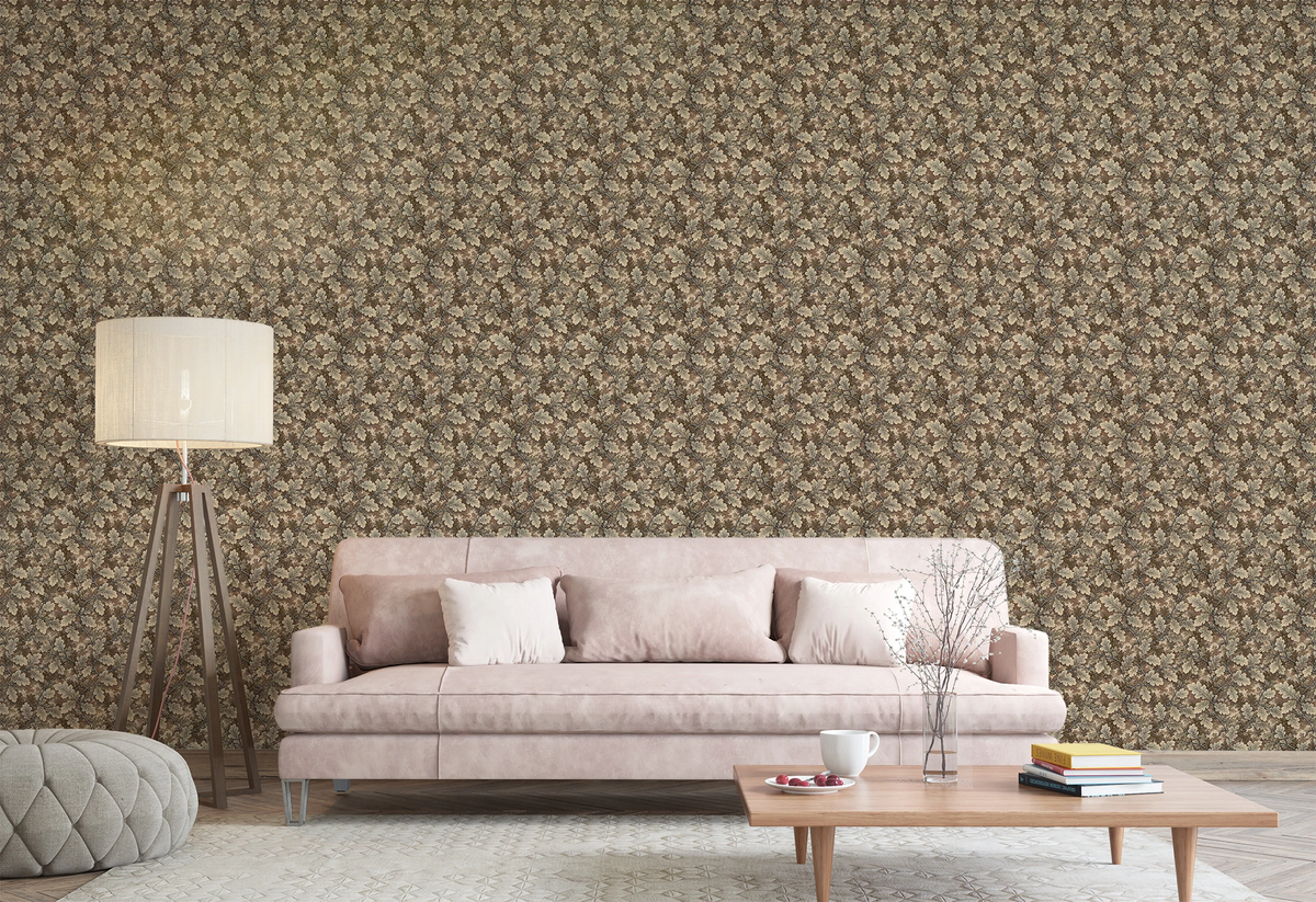 A modern living room with a beige sofa, a floor lamp, and a wall featuring a tapestry wallpaper in an oak leaf pattern. 