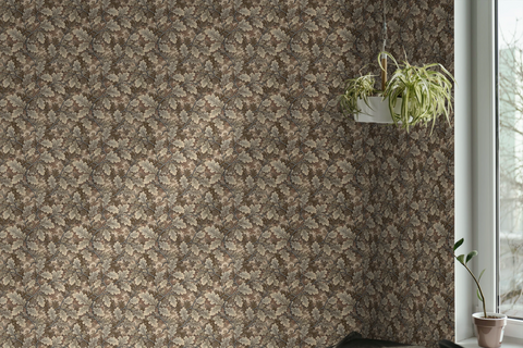 A  wall featuring a tapestry wallpaper in an oak leaf pattern, a pot hang from a string, next to a window to the outside. 