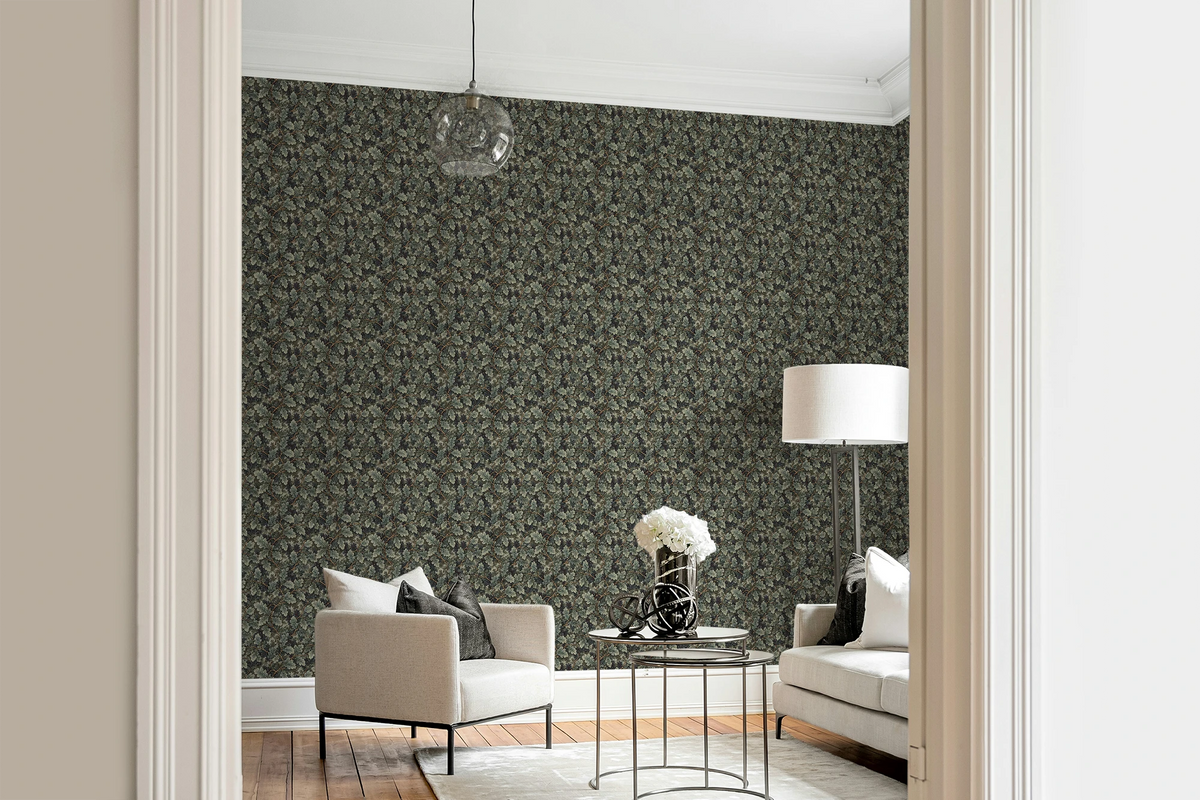 Modern living room with a white sofa, a glass sofa table, and a wall with a tapestry wallpaper featuring a green oak leaf pattern. 