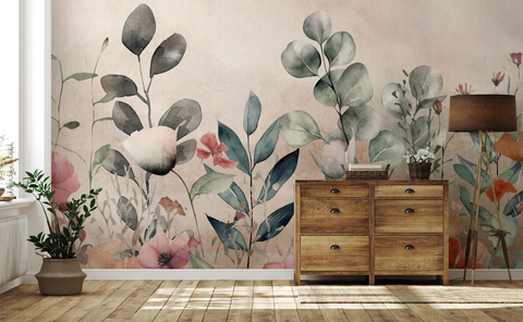 Botanical floral wallpaper with pastel flowers and green foliage behind a rustic wooden chest and woven baskets.