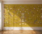 Chinoiserie wallpaper with floral and bird design on a yellow background, featuring flowers and peacocks. 