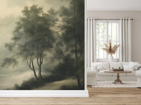 A hallway leading into a living room with a white lounge chair and white sofa, and a wallpaper featuring a vintage forest in green, with a texture of a painting. 