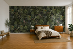 Modern bedroom with a tropical wallpaper, bed, and wooden floor.