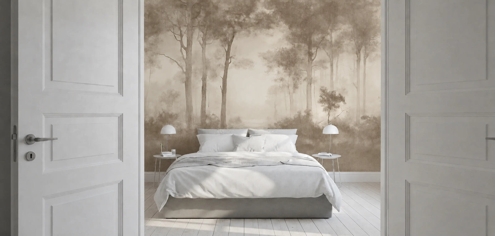 A bedroom interior viewed through open white doors, centered on a bed with white bedding and a large wallpaper mural showing a misty forest scene in soft beige and brown tones.